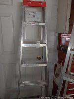 Full view of the five foot aluminum step ladder showing structure and condition.