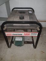 Front view showing Coleman Powermate 5000 Powerbase Extended Run label and black metal frame
