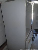 Fridge exterior, side view with door slightly open