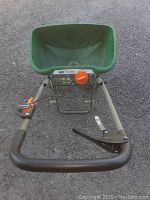 Top view of green basin wheelbarrow with black handles and metal frame