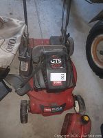 Top view of red Toro lawn mower with black engine cover and attached push handle, showing overall condition and configuration.