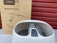 Naipo Steam Foot Spa with box in background, showing brand and model name.
