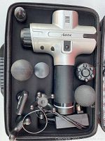 Overview of massage gun with six attachments in open case