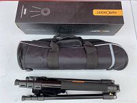 Folded black K&F Concept tripod and black carry bag above it, shown with the original product box.