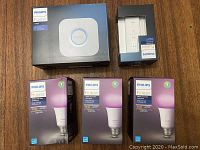 Overview of sealed boxes: Hue Bridge, dimmer switch, three Hue White and Color Ambiance bulbs