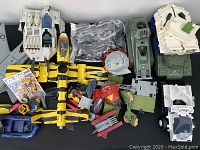 Full lot overview showing all vehicles, boat, parts and comic