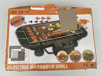 Box of Ba Blaie electric barbecue grill showing 2000W power and product image with grill skewers and cooked food.