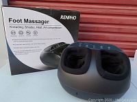 Renpho Foot Massager with packaging box showing product features kneading, shiatsu massage, heat, and air compression.