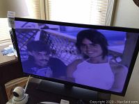 Westinghouse 32 inch LED TV displaying an image showing two people.