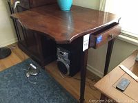 Side view of the solid wood end table showing the gate fold leaf and drawer with knob handle.