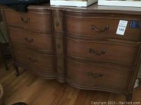 Front view of entire dresser showing serpentine front and six drawers