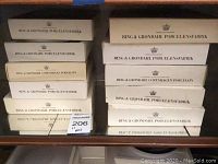 Stacked Bing & Grøndahl porcelain plate boxes showing brand and porcelain factory names.