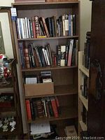 Full view of bookcase filled with books.