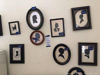 Wall display of 6 silhouette cameo framed artworks of various sizes and frame styles.