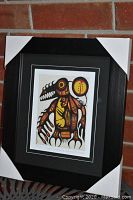 Image of professionally framed and matted artwork "Copper Thunderbird" by Norval Morrisseau showing full framed piece with protective corner covers.