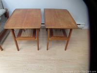 Two teak end tables side by side on light wood floor