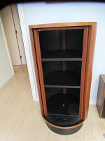 Open front view showing three interior shelves and cylindrical form