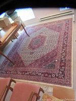 Overhead view of full carpet laid under table in room