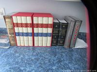 Front view of entire lot: Gibbon set in red slipcases, Darwin, Oxford volumes, and two modern titles