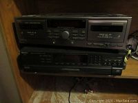 Front view of JVC double cassette deck stacked on top of Technics 5-disc CD changer.
