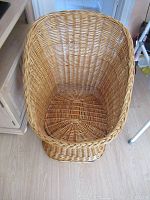 Top view of the rattan chair showing the woven oval seat and high curved backrest.
