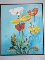 Full view of framed painting depicting colorful poppies in bloom on a blue background.