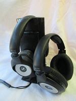 Pair of over-ear Sennheiser HDR 170 wireless headphones seated on charging base