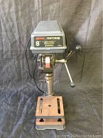 Front view of the Sears Craftsman 8-inch industrial drill press showing the adjustable worktable and front control lever handles.