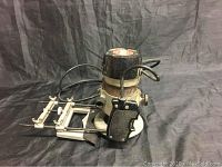 Full view of Sears Craftsman router with adjustable guide attachment, showing tool body, handle, and power cord.