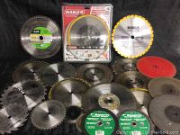 Assortment of saw blades and cut-off wheels displayed on black background