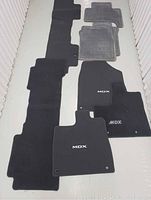 Full set of 8 car mats in black and gray with MDX and Lexus logos, laid flat on floor.