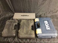 Three hard plastic tool cases shown closed, one white silver labeled Mastercraft Maximum, one blue Ryobi case, and one black case.