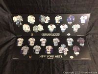 Photo of two wooden plaques featuring Chicago Cubs and New York Mets miniature jerseys mounted on black background