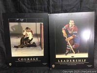Two wooden plaques with photos of hockey players and inspirational words 'Courage' and 'Leadership'.