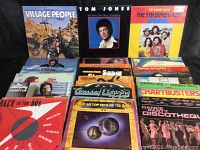 Photo showing front covers of several vinyl record albums including Village People, Tom Jones, The 5th Dimension, and others, arranged standing upright and overlapping, highlighting the variety of genres and colorful album art.