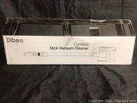 Front of sealed box branded Dibea Cordless Stick Vacuum Cleaner