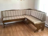 Full view of assembled L-shaped banquette in corner, showing upholstery pattern and wood frame.