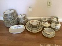 Full set of vintage Bavaria Tirschenreuth china showing all plates, cups, saucers, bowls, and serving pieces arranged on floor.