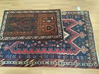 Both rugs stacked showing full extent of large and small rug designs
