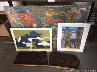 Photo showing the set of three framed art prints and two carved wood plaques arranged together