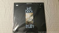 Front cover of Jeff Beck Truth vinyl album showing black background with album title and artwork.