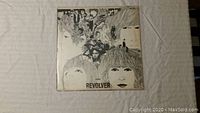Front cover of The Beatles Revolver vinyl album showing illustrated band portraits.