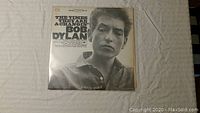 Front cover of Bob Dylan's vinyl album The Times They Are A-Changin', black and white close-up photo of Bob Dylan's face