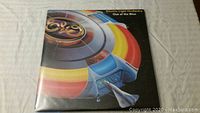 Front cover of ELO record "Out of the Blue" with colorful spaceship and logo.