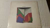 Front cover of Jim Hall vinyl record album showing abstract colorful geometric shapes artwork with the name Jim Hall at the top.