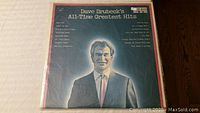 Front cover of Dave Brubeck's 'All-Time Greatest Hits' vinyl record showing a portrait of Dave Brubeck.