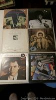 Photo showing 6 vinyl records in two rows including Robert Palmer albums and one with a woman with afro hairstyle