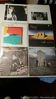 Photo showing six vinyl record albums including Genesis, Howard Jones, Al Stewart