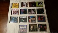 Top view of 15 jazz CD jewel cases laid out on a light-colored surface showing cover art and titles.
