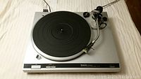 Technics SL-Q2 turntable showing platter, tonearm, and controls.